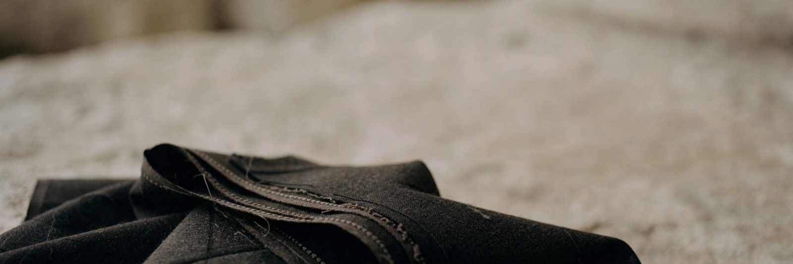 Atelier detail: dark tailored fabric in low light